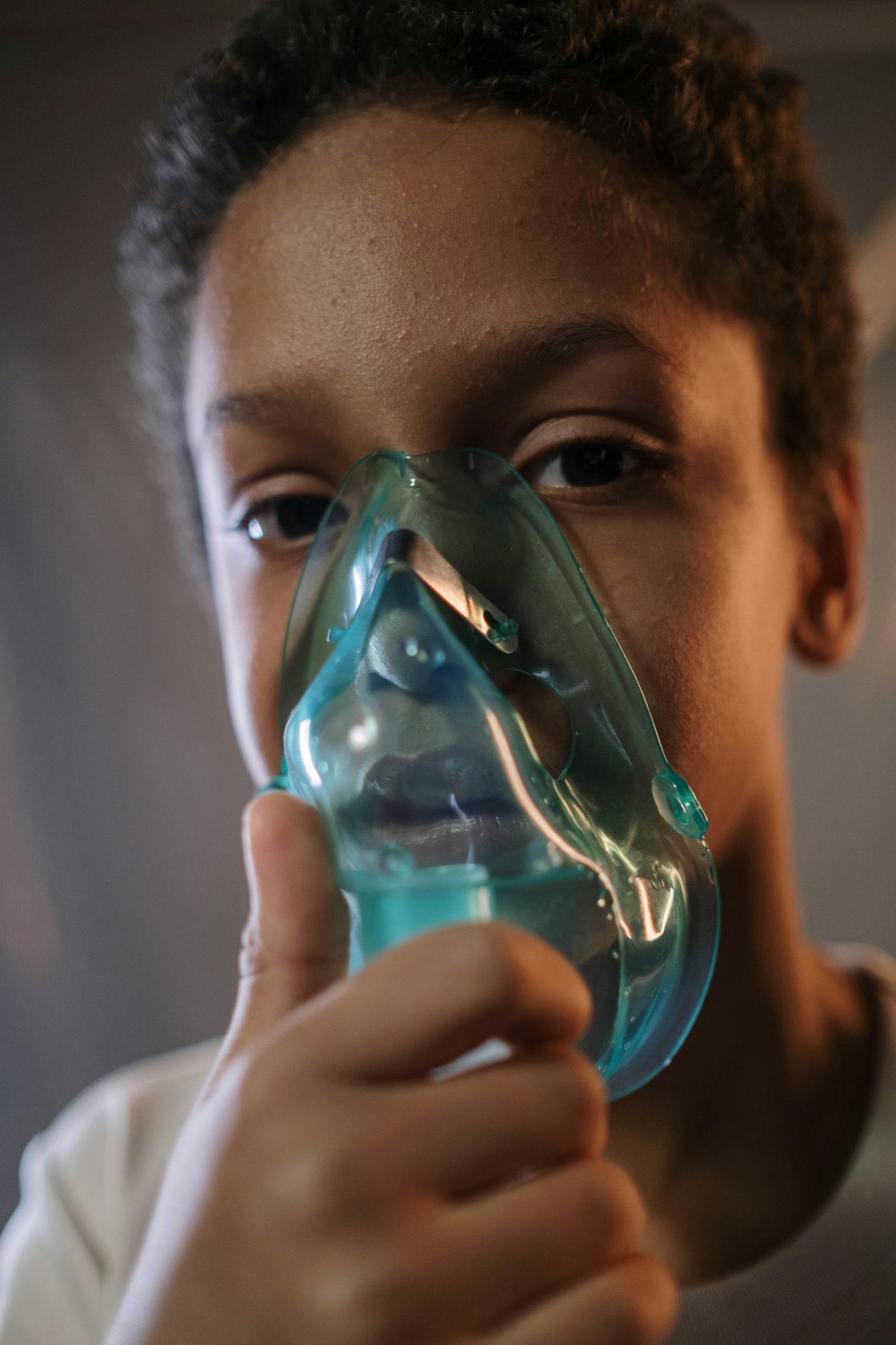 Child using inhaler for breathing concern